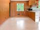 The kitchen features wood paneling, white countertops, and a breakfast bar at 3323 Baugh St, Raleigh, NC 27604