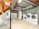 Basement laundry room showcasing side by side washer and dryer units at 3323 Baugh St, Raleigh, NC 27604