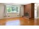 Bright living room with hardwood floors, brick fireplace and large window views at 3323 Baugh St, Raleigh, NC 27604