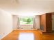 Bright living room with hardwood floors, a brick fireplace, and a large window overlooking the neighborhood at 3323 Baugh St, Raleigh, NC 27604