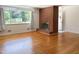 Spacious living room with hardwood floors and a brick fireplace at 3323 Baugh St, Raleigh, NC 27604