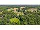 High-angle shot displays the entire horse property, complete with arena, pastures, and residential buildings at 3511 Corbett Rd, Mebane, NC 27302