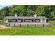 Exterior of white horse barn with dark trim, gravel yard, and multiple stalls at 3511 Corbett Rd, Mebane, NC 27302