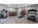 Spacious basement area featuring exercise equipment, a dining table, and a refinished piano at 3511 Corbett Rd, Mebane, NC 27302