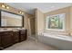 Relaxing bathroom with double vanity, soaking tub, and a separate shower at 3511 Corbett Rd, Mebane, NC 27302