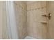 Tiled shower stall featuring neutral colors, decorative border, and updated shower head at 3511 Corbett Rd, Mebane, NC 27302