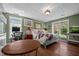 Bright bedroom with hardwood floors, desk, and large windows that let in plenty of light at 3511 Corbett Rd, Mebane, NC 27302