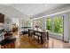Bright breakfast nook with hardwood floors, large windows, and rustic wood table at 3511 Corbett Rd, Mebane, NC 27302