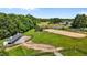 Aerial shot of an equestrian facility with horse barn, lush green pastures and paddocks at 3511 Corbett Rd, Mebane, NC 27302
