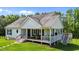 Charming exterior view of a bright white home with black shutters and a welcoming front porch at 3511 Corbett Rd, Mebane, NC 27302