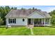 Charming front exterior of a well-maintained home, showcasing a cozy porch and beautiful landscaping at 3511 Corbett Rd, Mebane, NC 27302