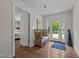 Hallway with hardwood floors and view to the outside through the glass paneled back door at 3511 Corbett Rd, Mebane, NC 27302