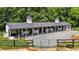 Large horse barn with multiple stalls and a gravel driveway at 3511 Corbett Rd, Mebane, NC 27302