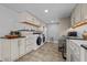 Convenient laundry room with white cabinets, modern washer/dryer, and counter space at 3511 Corbett Rd, Mebane, NC 27302