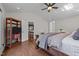 Comfortable main bedroom with hardwood floors, vaulted ceilings, and access to the en-suite bathroom at 3511 Corbett Rd, Mebane, NC 27302