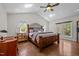 Serene main bedroom featuring hardwood floors, vaulted ceiling, and large windows at 3511 Corbett Rd, Mebane, NC 27302