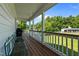 Spacious outdoor porch with a dark grill and seating area, perfect for entertaining and enjoying backyard views at 3511 Corbett Rd, Mebane, NC 27302