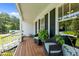 Relaxing front porch setting with comfortable wicker chairs, lush ferns, and views of the manicured front yard at 3511 Corbett Rd, Mebane, NC 27302