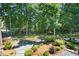 Landscaped backyard featuring dense trees and bushes, a manicured stone path and wooden fence at 3610 Long Ridge Rd, Durham, NC 27703