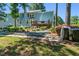 Backyard with manicured gravel, a wooden deck and a two-story blue house in the background at 3610 Long Ridge Rd, Durham, NC 27703