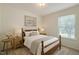 Cozy bedroom with natural light, neutral walls, and a wooden frame bed dressed with plush bedding at 3610 Long Ridge Rd, Durham, NC 27703