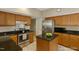 Traditional kitchen with oak cabinetry, stainless steel appliances and a center island at 3610 Long Ridge Rd, Durham, NC 27703