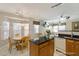 Well-lit kitchen featuring a central island, adjacent dining area, and comfortable living space at 3610 Long Ridge Rd, Durham, NC 27703