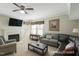 Cozy living room with a fireplace, a plush sofa, neutral walls, and a ceiling fan at 3610 Long Ridge Rd, Durham, NC 27703