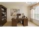 Home office with traditional wooden desk, bookcase, and large bright window at 3610 Long Ridge Rd, Durham, NC 27703