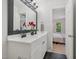 Bathroom featuring double vanity with matte black hardware and modern lighting fixture at 3973 Volkswalk Pl, Raleigh, NC 27610