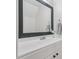Modern bathroom features a sleek white vanity and a stylish framed mirror at 3973 Volkswalk Pl, Raleigh, NC 27610