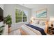 Cozy bedroom with a large window, offering natural light and a calming view at 3973 Volkswalk Pl, Raleigh, NC 27610