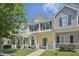 Inviting two-story townhome with green front door and charming front porch and well-manicured lawn at 3973 Volkswalk Pl, Raleigh, NC 27610