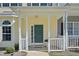 Charming covered front porch with green front door, white railings, and address signage at 3973 Volkswalk Pl, Raleigh, NC 27610