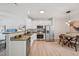 Modern kitchen featuring stainless steel appliances, white cabinets, and hardwood floors at 3973 Volkswalk Pl, Raleigh, NC 27610