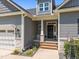Charming home entrance features a covered porch, beautiful stone accents, and well-manicured landscaping at 40 Cinnamon Teal Way, Youngsville, NC 27596