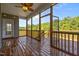 Covered patio featuring wood flooring and screened windows at 40 Cinnamon Teal Way, Youngsville, NC 27596
