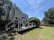 Backyard view with deck, lush lawn, and mature trees creates a private outdoor oasis at 4117 Mangrove Dr, Raleigh, NC 27616