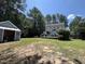 Backyard featuring a large yard, storage shed, and deck, perfect for outdoor activities at 4117 Mangrove Dr, Raleigh, NC 27616