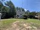 Spacious backyard featuring a large deck, mature trees, and ample space for outdoor activities and entertaining at 4117 Mangrove Dr, Raleigh, NC 27616