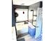 Bathroom with a gray wall, bathtub, and a sink with a mirror on the wall at 4117 Mangrove Dr, Raleigh, NC 27616