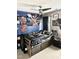 This bedroom includes posters, guitars, and a bed with a comforter at 4117 Mangrove Dr, Raleigh, NC 27616