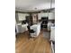 Well-lit kitchen with white cabinetry, stainless steel appliances, and an island with seating at 4117 Mangrove Dr, Raleigh, NC 27616