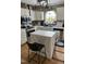 Modern kitchen with stainless steel appliances, white cabinetry, and a center island with seating at 4117 Mangrove Dr, Raleigh, NC 27616