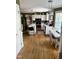 Bright eat-in kitchen featuring hardwood floors, white cabinetry, stainless steel appliances, and a center island at 4117 Mangrove Dr, Raleigh, NC 27616