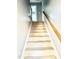 Carpeted staircase leading to the second floor, featuring a wooden handrail at 4117 Mangrove Dr, Raleigh, NC 27616