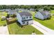 Aerial view of home with manicured lawn, landscaping, brick paver driveway, and fenced backyard at 413 Hallie Long Ln, Burlington, NC 27217