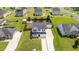 Aerial view of a home with a long driveway, mature landscaping, manicured lawn, privacy fence, and storage shed at 413 Hallie Long Ln, Burlington, NC 27217