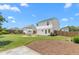 Spacious backyard features a stone fire pit, lush green grass, and a privacy fence for outdoor enjoyment at 413 Hallie Long Ln, Burlington, NC 27217