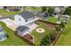 A large backyard features a fire pit, patio, storage shed, and manicured lawn with privacy fence and mature landscaping at 413 Hallie Long Ln, Burlington, NC 27217
